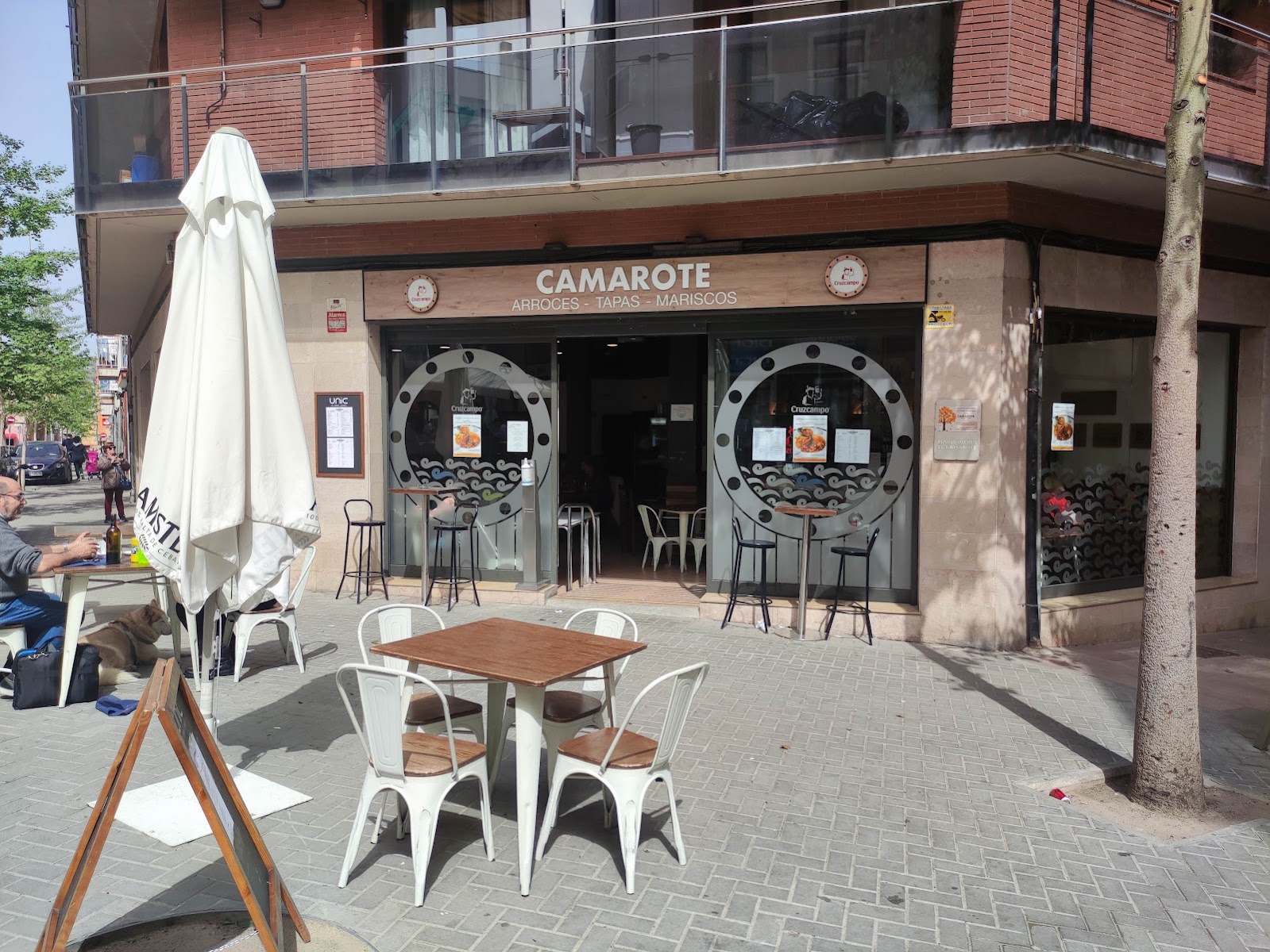 Restaurant storefront with porthole windows and outdoor seating