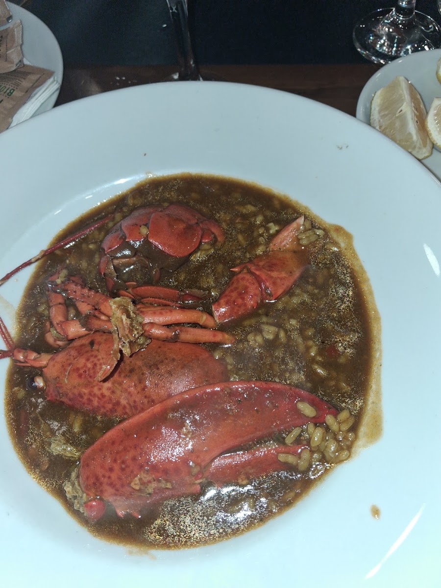 Whole lobster in dark sauce with rice